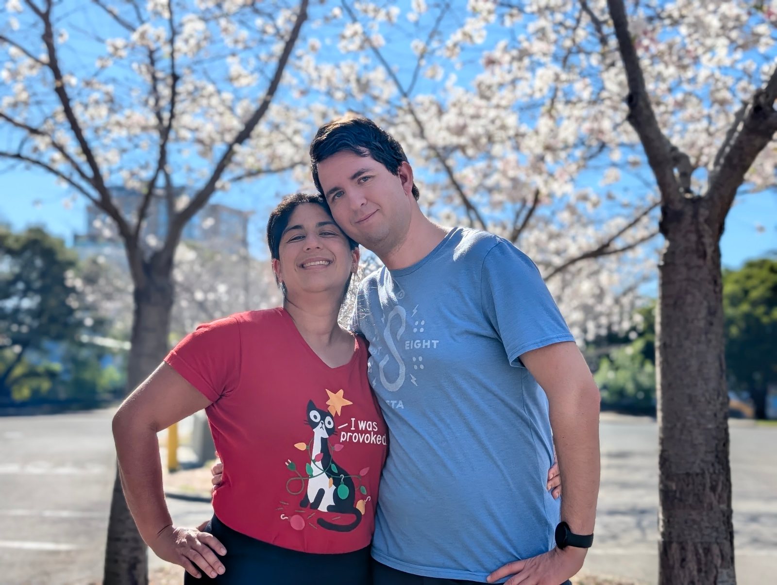 Leo and his wife under blooming cherry trees on the UC Berkeley campus