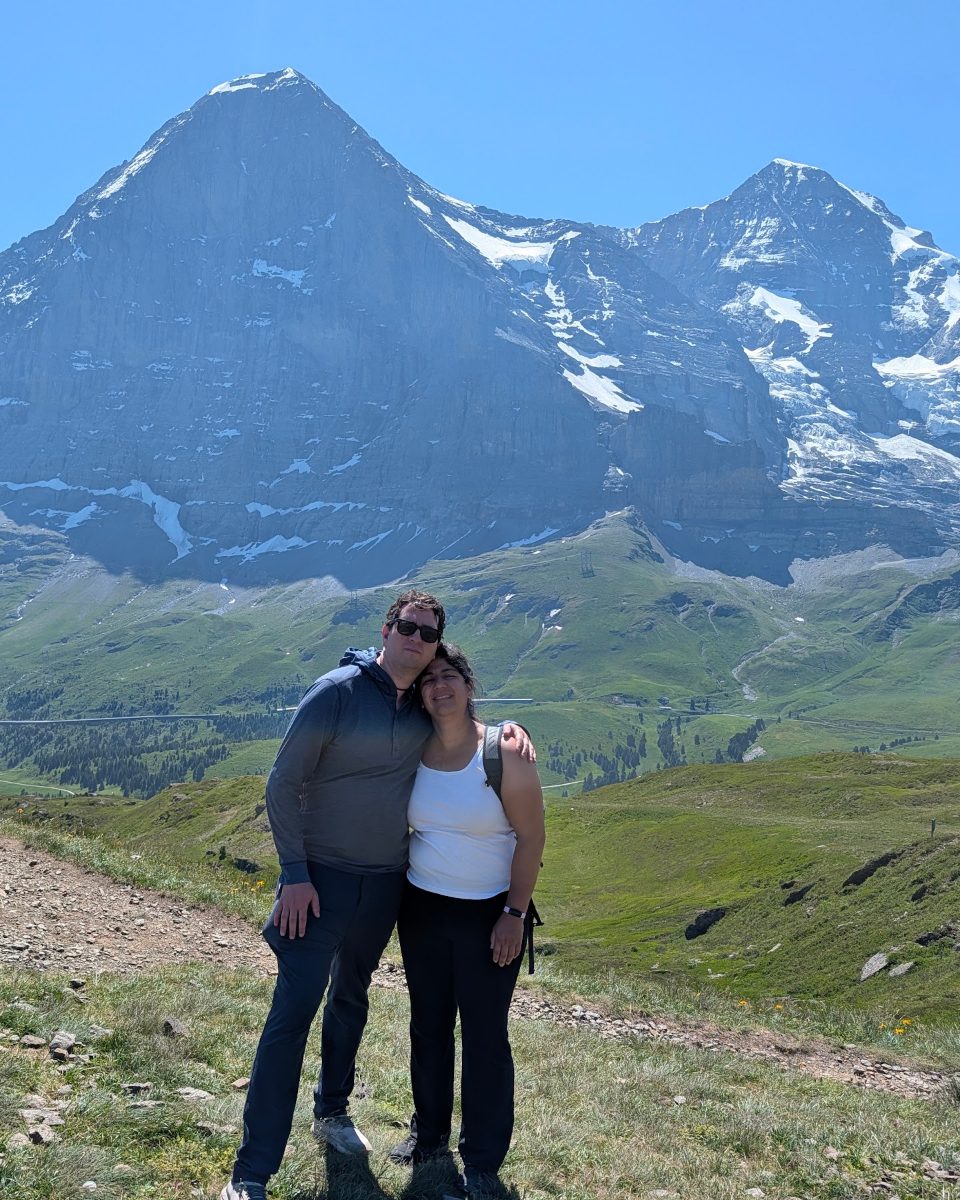 Leo and his wife on a hiking trail in the Swiss Alps, with the Eiger behind them